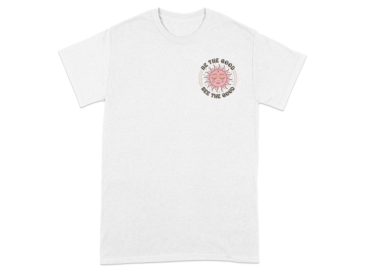 White t-shirt with a sun graphic and text "Be the good, see the good."