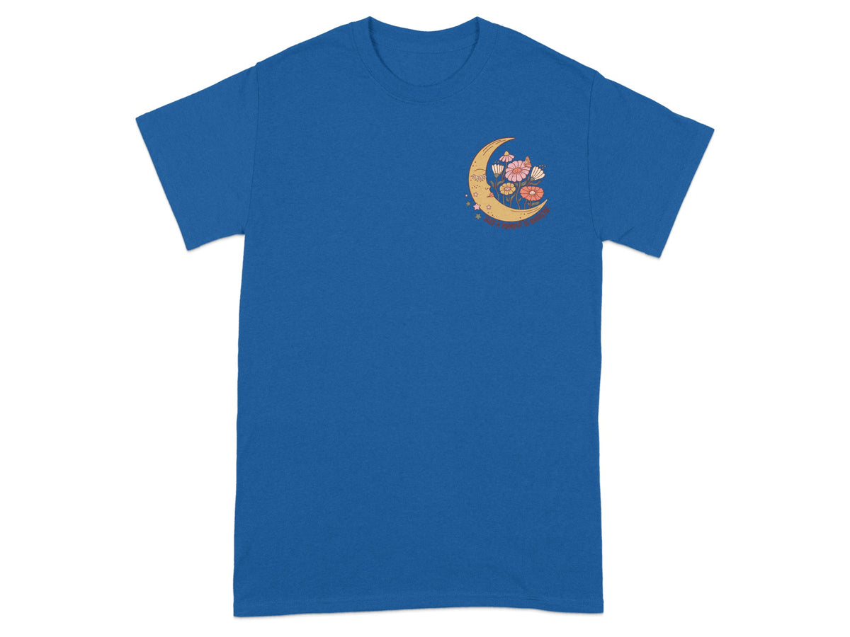 Blue t-shirt with a crescent moon graphic featuring flowers and text.